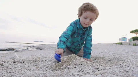 Slow-Mo: Boy Playing With Pebbles On Beach In Summer Stock Footage 35295200