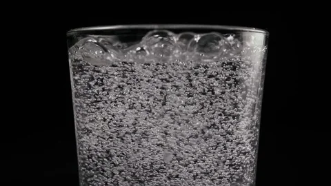 Slow mo. Bubbles in a glass of water Stock Footage 74761695