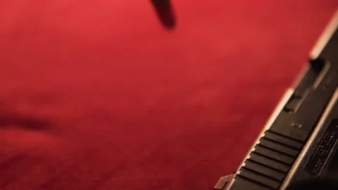 Slow Mo Bullets dropping besides gun 動画素材 230625248