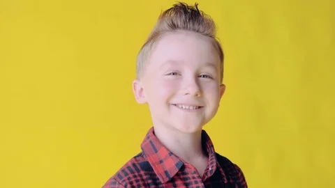 SLOW MO: Cheerful nice young smiling boy looking at the camera. Blonde boy on a Stock Footage 77554986