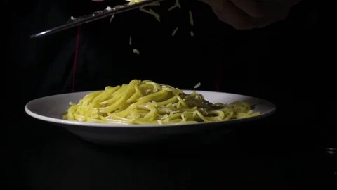 Slow mo chef rubs cheese on spaghetti pasta Stock Footage 72432827