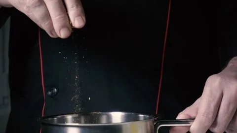 Slow mo chef throws flavoring Stock Footage 71312631