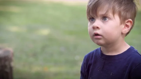 Slow mo of a child dropping his toy and looking up to his dad for approval Stock Footage 55390931