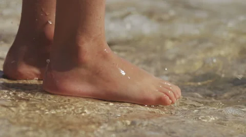 Slow-Mo: Childs Feet Stomping Sea Water Splashing Stock Footage 35288299