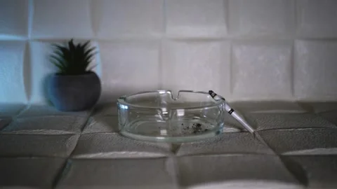 Slow mo. The cigarette fell from the ashtray. Smoke from a cigarette. Cigarettes Stock Footage 243220754