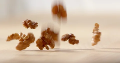 Slow Mo Close Up Walnuts Fall On Kitchen Counter Stock Footage 112863222