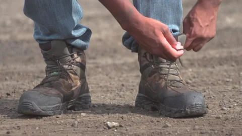 Slow-Mo Construction Worker Tying Boot Stock Footage 172163816