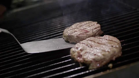 Slow-mo cooking a hamburger burger, in the kitchen a cook is on fire Stock Footage 128116404