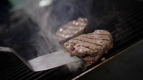 Slow-mo cooking a hamburger burger, in the kitchen a cook is on fire Stock Footage 128116458