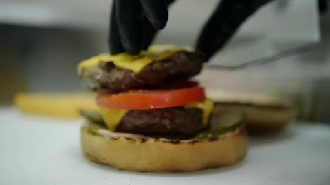 Slow-mo cooking a hamburger burger, in the kitchen a cook is on fire Stock Footage 128116730