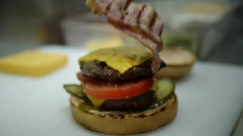 Slow-mo cooking a hamburger burger, in the kitchen a cook is on fire Stock Footage 128116757