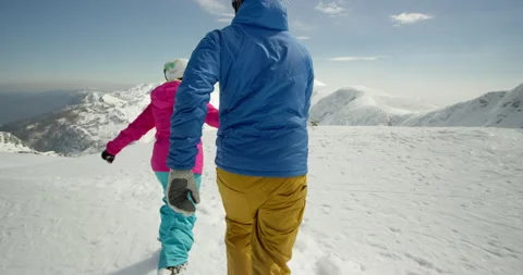 Slow Mo Of Couple Holding Hand And Running On Snow Stock Footage 140120091