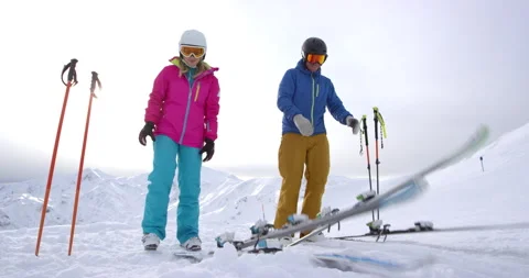 Slow Mo Of Couple Preparing To Go Skiing Stock Footage 140324809