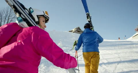 Slow Mo Of Couple Walking Uphill With Ski Gear Stock Footage 140116509