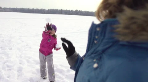 Slow-Mo: Cute Girl Throwing Snowballs At Her Mother Stock Footage 33849566