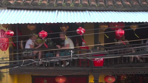 Slow mo of diners on second level of a cafe in Hoi An Stock Footage 271181315