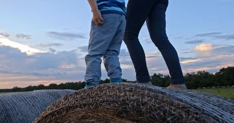 Slow-Mo Establishing Shot Mom And Son Jumping On Hay Stock Footage 90879659