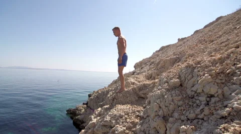 Slow-Mo: Fit Young Man Jumping Head First Into Clear Blue Water Stock Footage 39621934