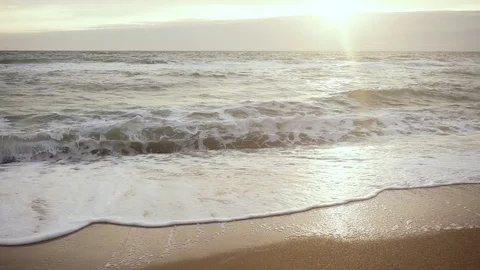 Slow mo foam wave on the sand Stock Footage 82970929