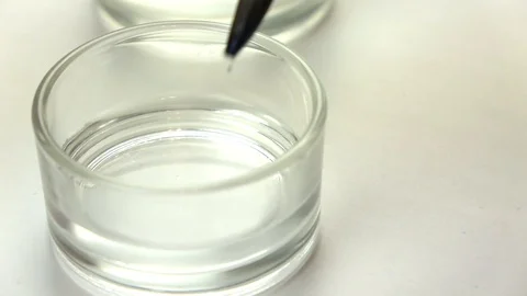 Slow-mo footage. Close-up shot of turquoise watercolor is being blending in a Stock Footage 87143888