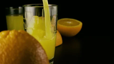Slow mo. Fresh orange juice pour into a glass Stock-Footage 74920341