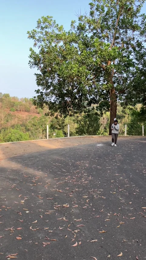 Slow mo front view of hijab woman jogging on rural asphalt road. Видео 342369277