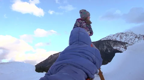 Slow-Mo: Girls Pulls Sledge With Her Younger Brother On Top Of The Hill Stock Footage 45307927
