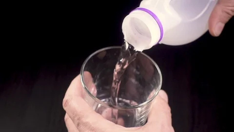 Slow mo in a glass water flows from a canister Stock Footage 87468591