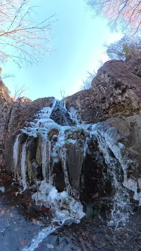 Slow-mo Half Frozen Waterfall Portrait shot 動画素材 294706859