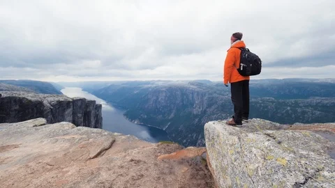 Slow mo. Hiker with backpack enjoying the view, standing on top of the mountain Stock Footage 87867163