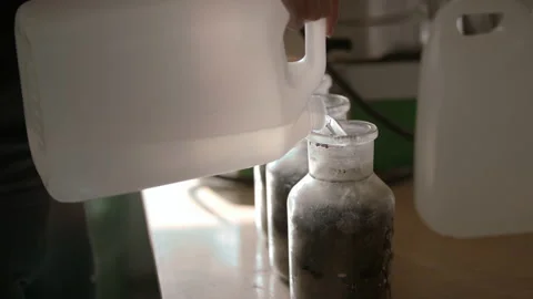 Slow-mo: Lab Technician Pours Demineralized Water to Glass Bottle Stock-Footage 138805128