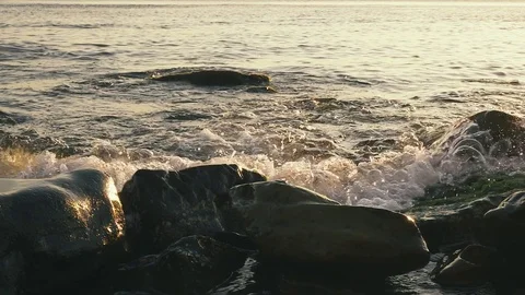 Slow mo large stones in the foreground in water Stock Footage 81176900