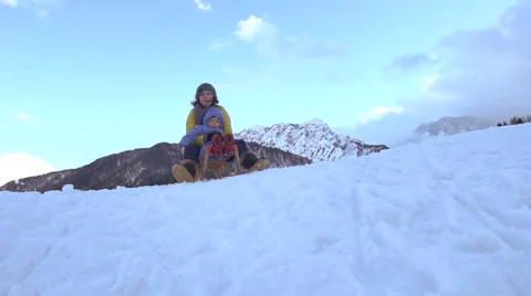 Slow-Mo: Little Boy Enjoys Tobogganing On Snow With His Mom Stock Footage 45307774