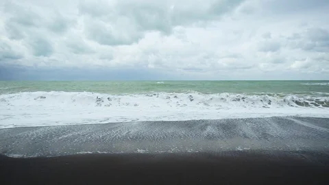Slow mo long wave on the black shore Stock Footage 82311632