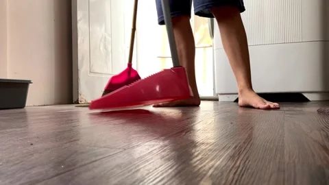 Slow mo low angle view of housewife mopping wooden floor. Stock Footage 345043678