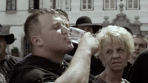 Slow Mo Man Drinks Water In Crowd Stock Footage 120014393
