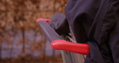 Slow Mo Of Man Pushing A Shopping Cart With Clothes Stock Footage 128774444