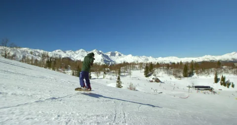 Slow Mo Of Man Snowboarding During Winter Stock Footage 139396329