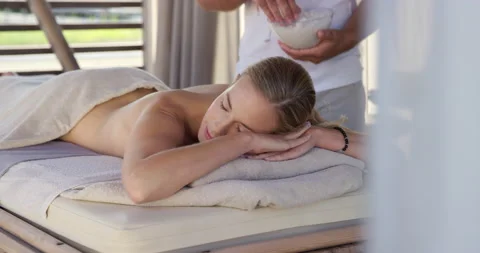 Slow Mo Of Masseur Putting Salt Scrub On Client Stock Footage 141919447