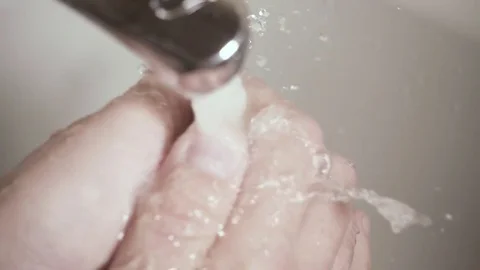 Slow mo men's hands under the faucet with soap top view Video stock 83684734