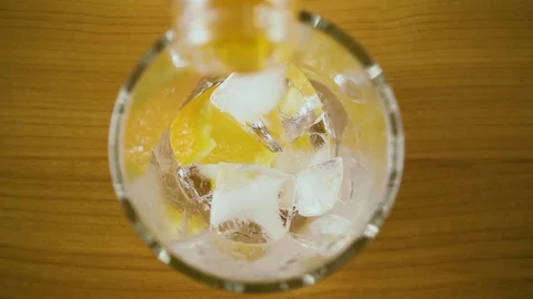 Slow mo. Orange drink in a glass to pour top view Stock Footage 76766328
