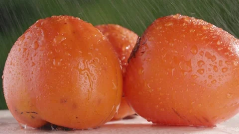 Slow mo persimmon close up. Persimmon under running water Stock Footage 147081258