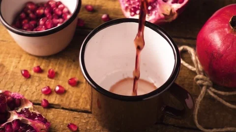 Slow mo pomegranate juice in a mug Stock Footage