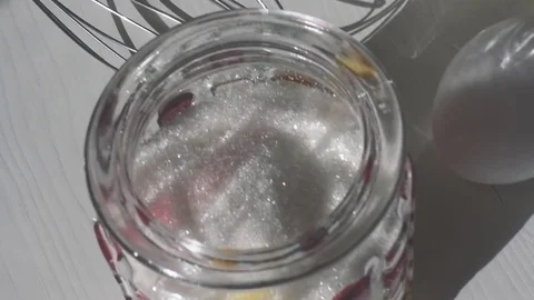 Slow mo. Pour sugar from sugar bowl into flour Stock Footage 75377762