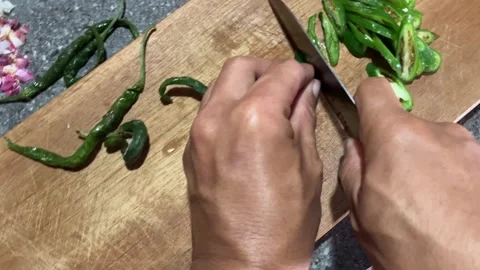 Slow Mo Pov Hands Slicing Green Chilli With Knife On Wooden Board.-3 Stock Footage 344523602