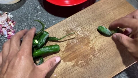 Slow Mo Pov Hands Slicing Green Chilli With Knife On Wooden Board. Stock Footage 344523604