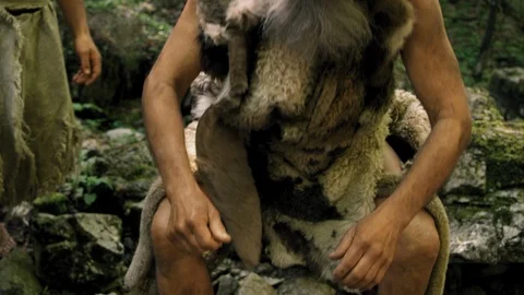 Slow Mo Prehistoric Man Takes Long Drink From Stream Stock Footage 113350357