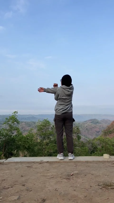 Slow mo rear view of hijab woman stretching arms outdoors. Stock Footage 342369394