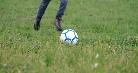 Slow Mo Of School Boy Kicking A Football Stock Footage 125241189