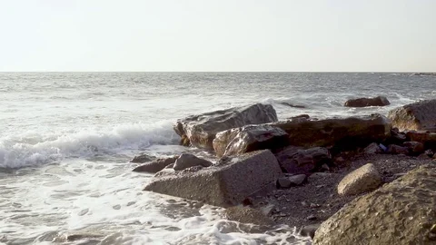 Slow mo sea wave rolls to the shore and breaks Stock Footage 82385346